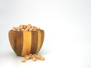 Chickpeas in wooden bowl isolated on white background