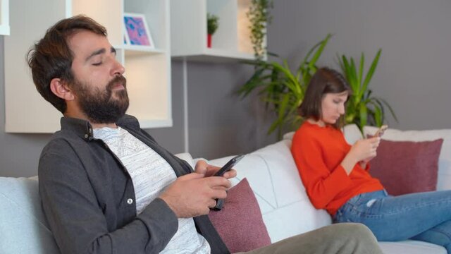 Husband And Wife Hanging Out At Home. Nervous Glances. Phone Addiction.