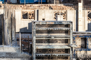 Reinforced concrete foundation of a modern monolithic residential building. Prepared formwork with reinforcing mesh for pouring concrete. Monolithic construction technologies.