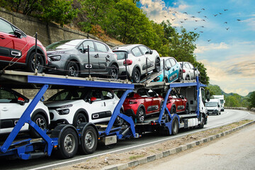 Hauling cars. Car carrier. Truck carrying cars. No logo or brand.