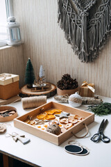 Eco friendly zero waste dried orange slices and DIY tools and stuff on the table. Handmade dried orange for Christmas decorations and Christmas presents.