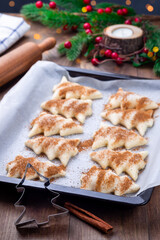 Ready to bake Christmas tree shaped puff pastry cookies with sugar and cinnamon