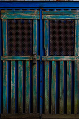 Old wooden gate painted in blue in a Brazilian city