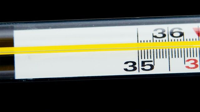 Glass Mercurial Thermometer On A Black Background