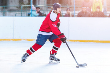 Professional ice hockey player in attack on the rink.
