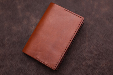 Handmade products made of genuine brown leather. Leather passport cover, leather wallet. Leather goods for men. The view from the top