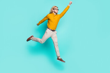 Fototapeta na wymiar Full length profile side photo of young man happy positive smile jump air fly superman isolated over turquoise color background
