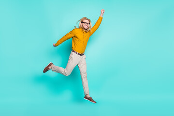 Fototapeta na wymiar Full body profile side photo of young man happy positive smile jump up catch umbrella isolated over turquoise color background