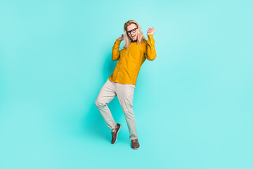 Fototapeta na wymiar Full size photo of young handsome man have fun dance party enjoy excited isolated over turquoise color background