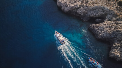 Top view from drone of speed boat in the blue water