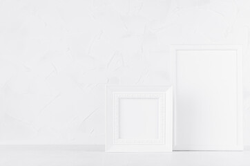 Simple modern white wood blank rectangle and square photo frames on wood board in gentle simplicity soft light interior with plaster wall. Mockup for presentation, portfolio, message, text, design.