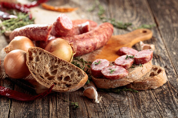 Sausage sandwich on an old wooden table.