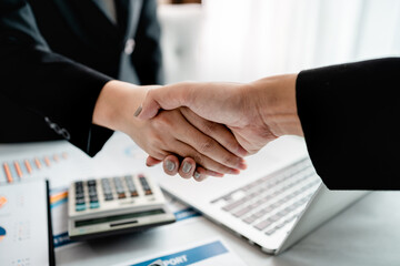 Close up of business people shakes hands after discussing finish business agreement at the workplace, business partnership meeting, successful teamwork concept.