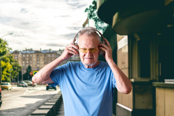 old senior man listen music in headphones