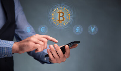 man holding phone with virtual bitcoin