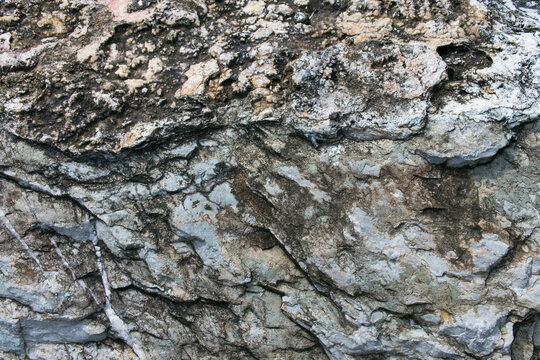 Huge Cracks And Layers. Coarse, Rough Gray Stone, Rock Texture Of Mountains Background