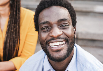 Happy african young man smiling on camera outdoor