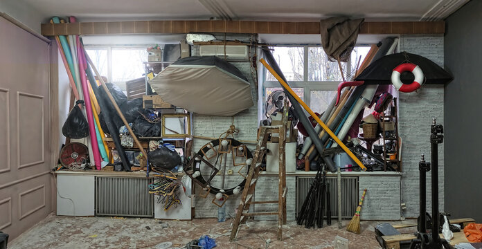Preparing for repair at a photographic studio. All equipment, lights and decorations are raised up on the windows to free the floor.