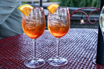 Aperol spritz cocktail drinks with orange wedge garnish
