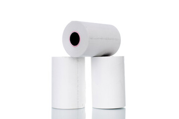 Three rolls of paper cash register tape, close-up isolated on white.