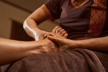 Obraz na płótnie Canvas Licensed massage therapist massaging customer lower limb