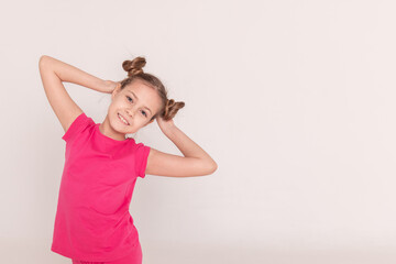portrait of a beautiful girl with tails in pink clothes on a white isolated background