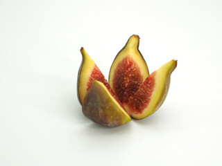 Fig fruit cut in the shape of a flower on a white background. Close-up