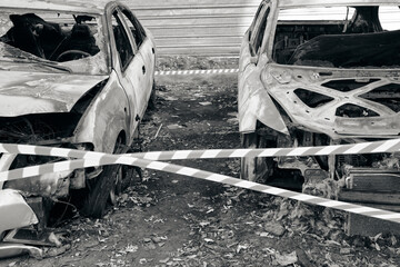 Skeletons of two burnt out cars after fire.