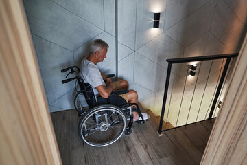Male wheelchair user having problems with climbing down stairs