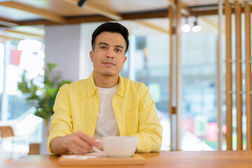 Portrait of handsome young man at coffee shop