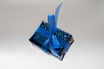 Gift blue box with blue bow. Christmas sinlge gift box isolated.