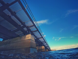 slipway bridge going into the sea from underneath