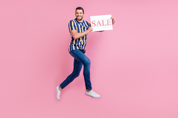 Full size profile photo of funky young brunet guy jump sale wear t-shirt jeans sneakers isolated on pink background
