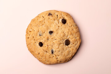 Giant handmade cookie with chocolate chips isolated on pink background. Flat lay. Top view.