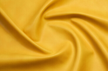 yellow artificial leather with waves and folds on PVC base