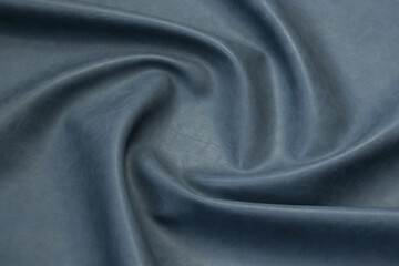 blue artificial leather with waves and folds on PVC base