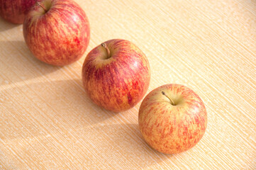apples on top of a light-colored table