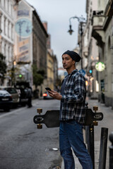Man holding skateboard in Budapest street