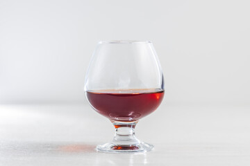 A glass of cognac on a white background