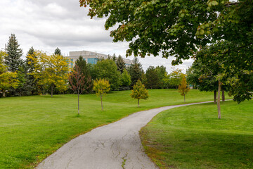 Centrepointe public park in Ottawa, Canada with trail, trees and green grass in early fall
