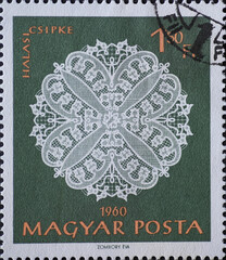 ungary circa 1960: A post stamp printed in Hungary showing an ornate white halas lace work against...
