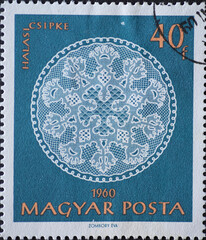 Hungary circa 1960: A post stamp printed in Hungary showing an ornate white halas lace work against...