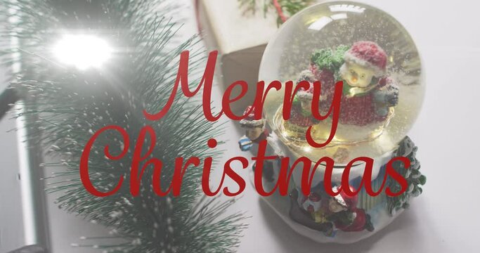 Animation of merry christmas text over snow globe