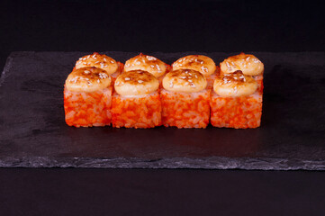 sushi on a black plate