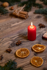 Traditional Czech Christmas on wood decoration with twig, candle, apple, orange, fruit