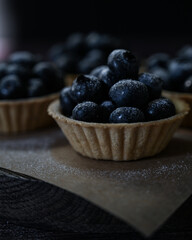 blueberries and tartlets sprinkled with powdered sugar