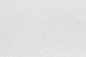 Uniform snow cover. Snow texture on a flat plot of land