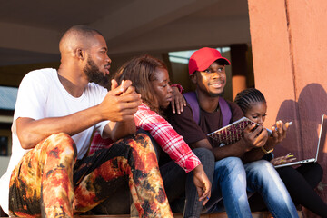 group of african students sitting on a stair case