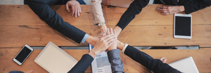 Group of businesspeople holding hand together after success work. Collaboration of Group of...