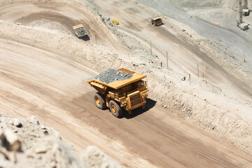 Huge dump trucks loaded with mineral  in a copper mine in Chile.
